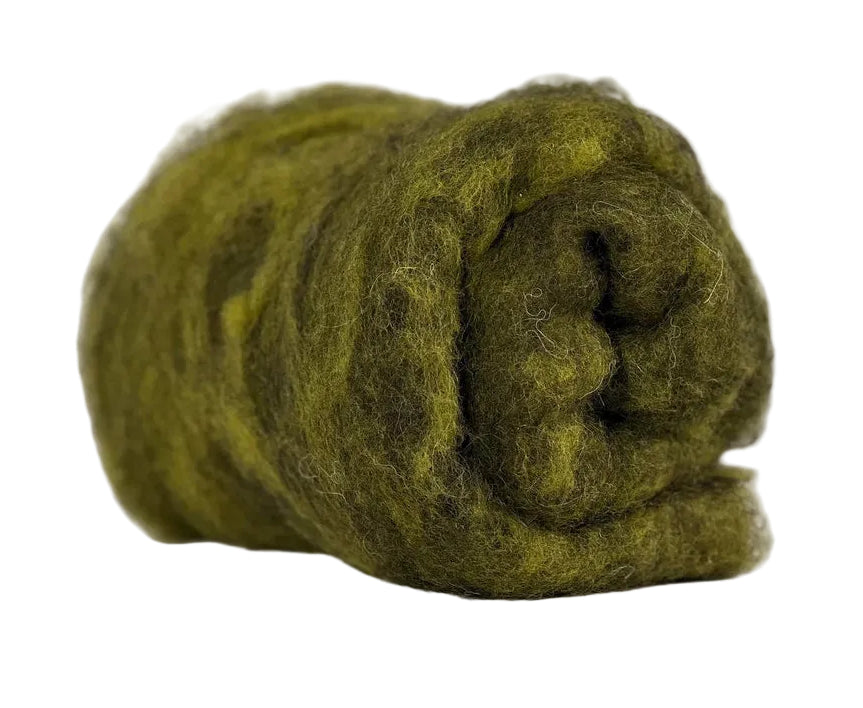 Rolled green wool on a marble surface with a blurred background