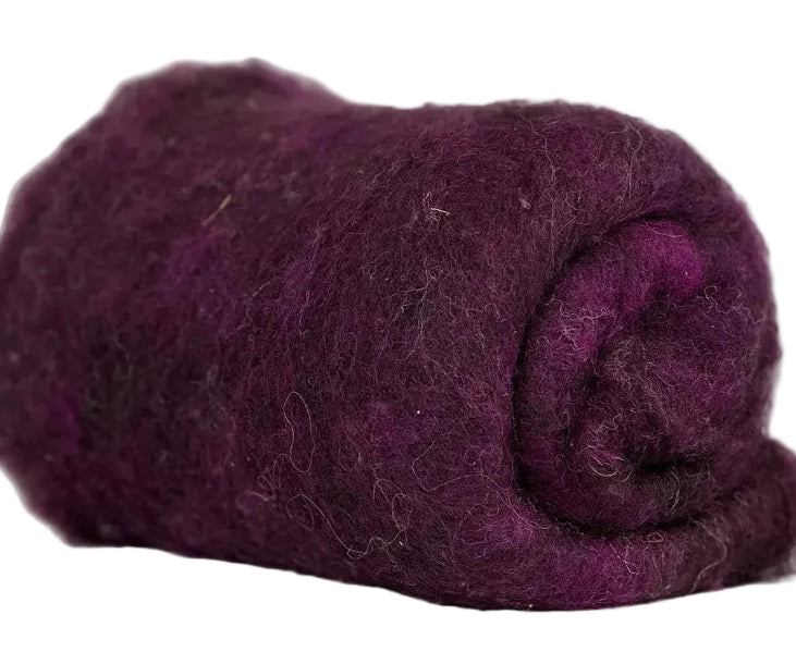Rolled-up purple fabric on a marble surface