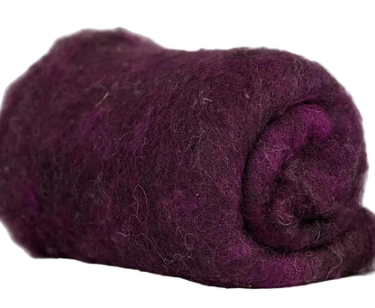 Rolled-up purple fabric on a marble surface