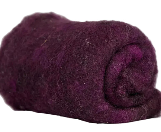 Rolled-up purple fabric on a marble surface